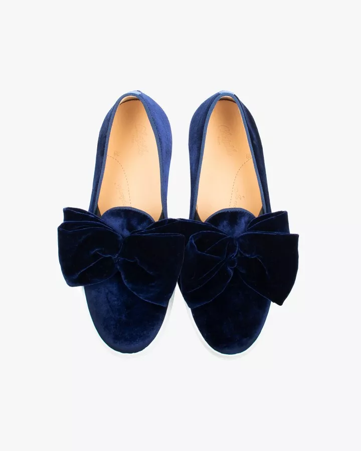 Navy blue velvet slip-ons with oversized bow